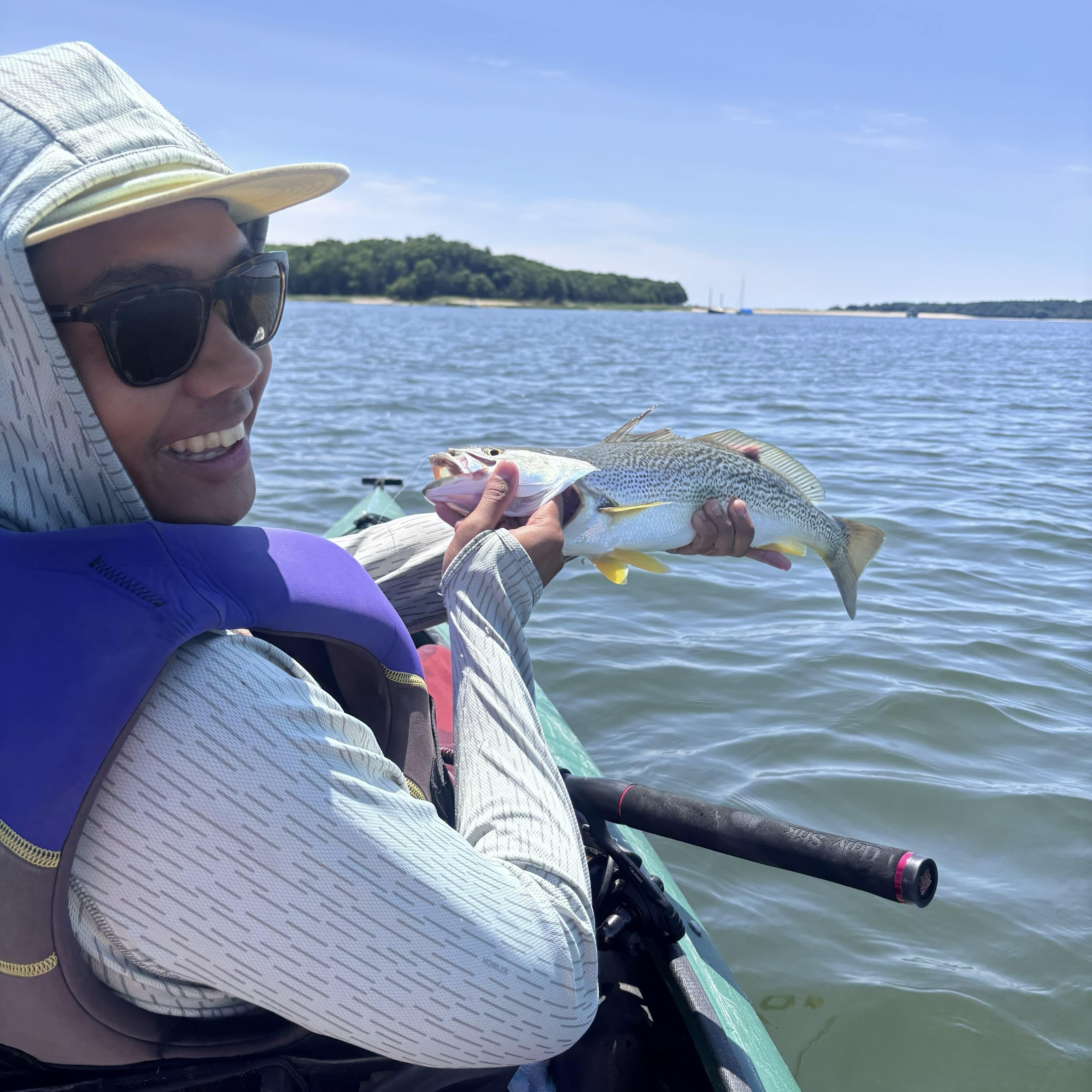 Weakfish being held on kayak